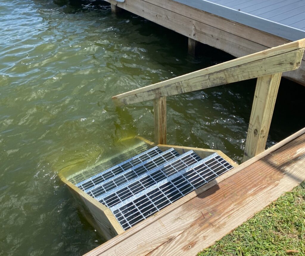Dock Stairs & Slip-Guard Steps Lake Conroe 1 Metal grate dock stairs descending into Lake Conroe
